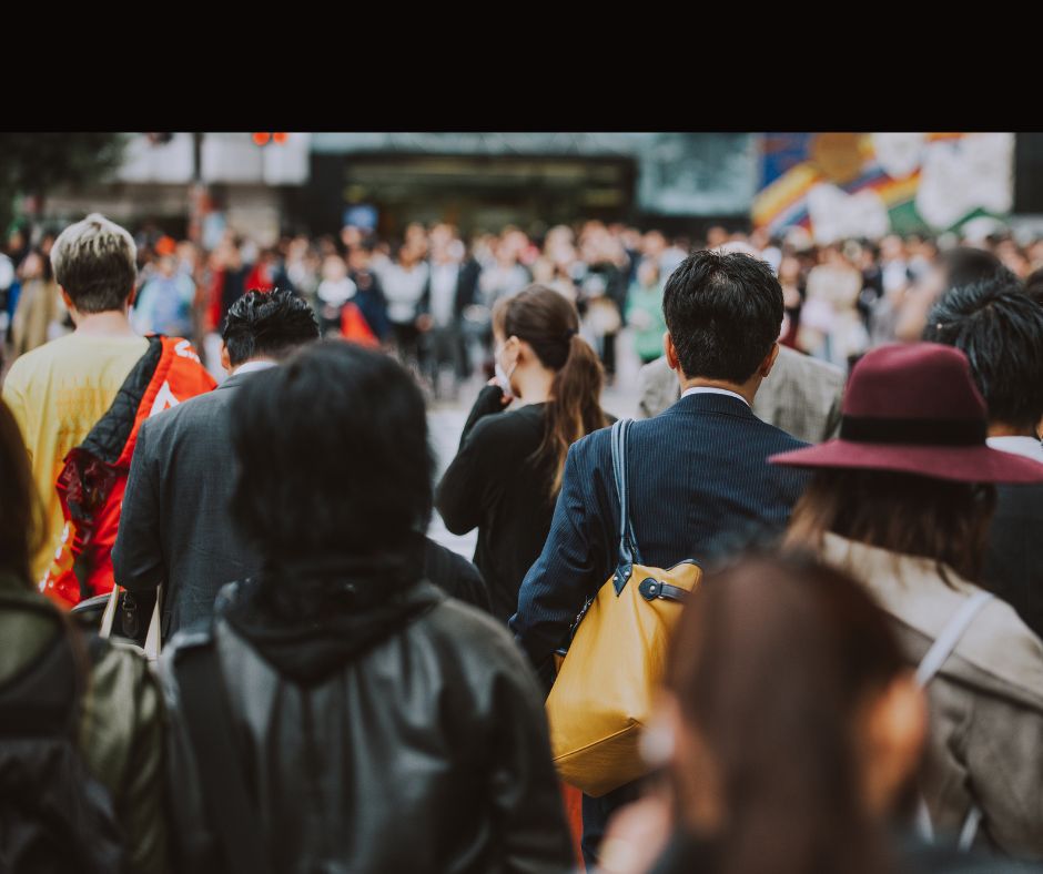 The back of a man disappearing into the crowd