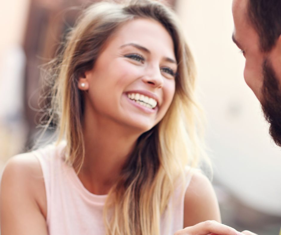 A woman smiling at the person she loves