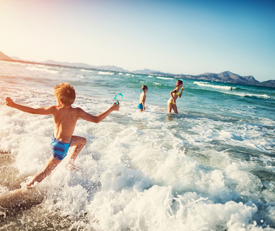 Young people frolicking on the beach