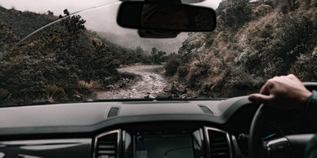 car passing on cliff road