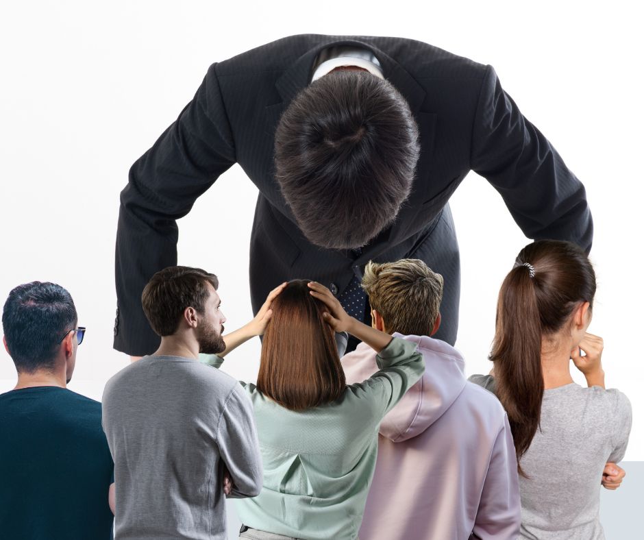 A man bowing his head and apologizing